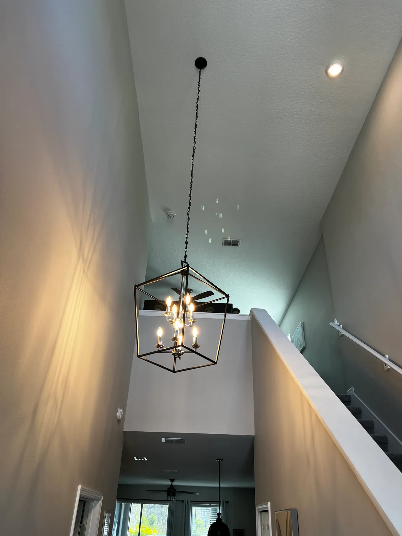 Chandelier installation in DeLand home